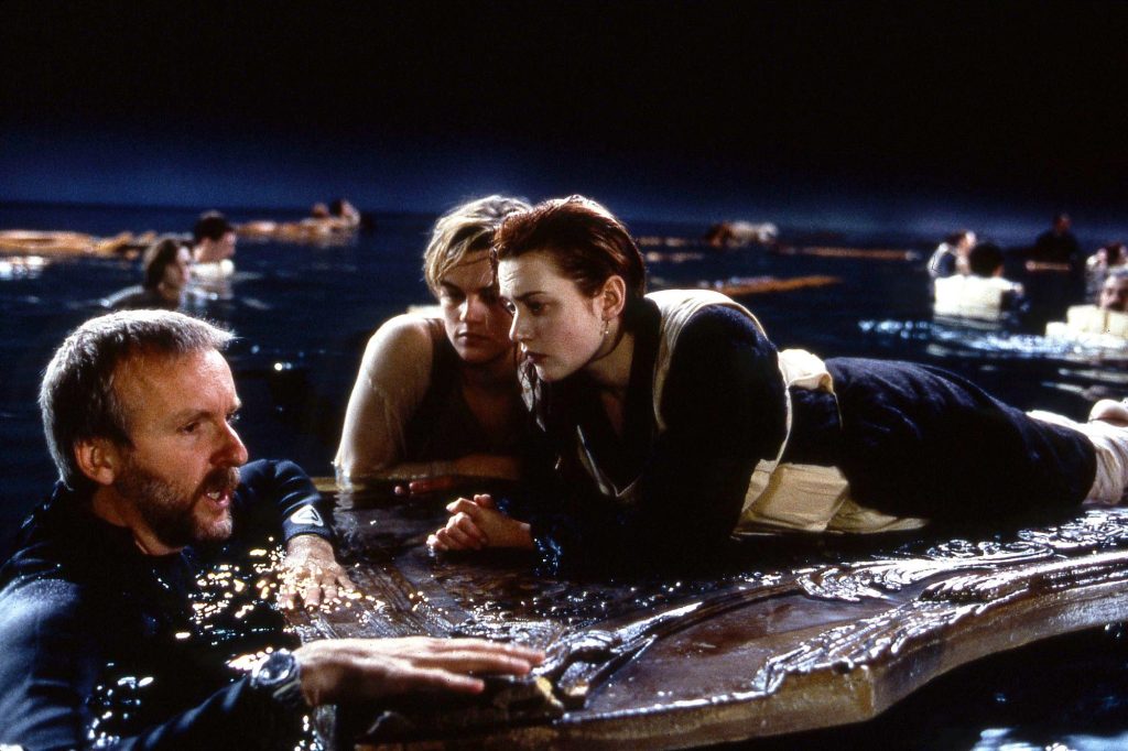 Titanic director James Cameron behind the scenes directing lead stars Leonardo DiCaprio and Kate Winslet